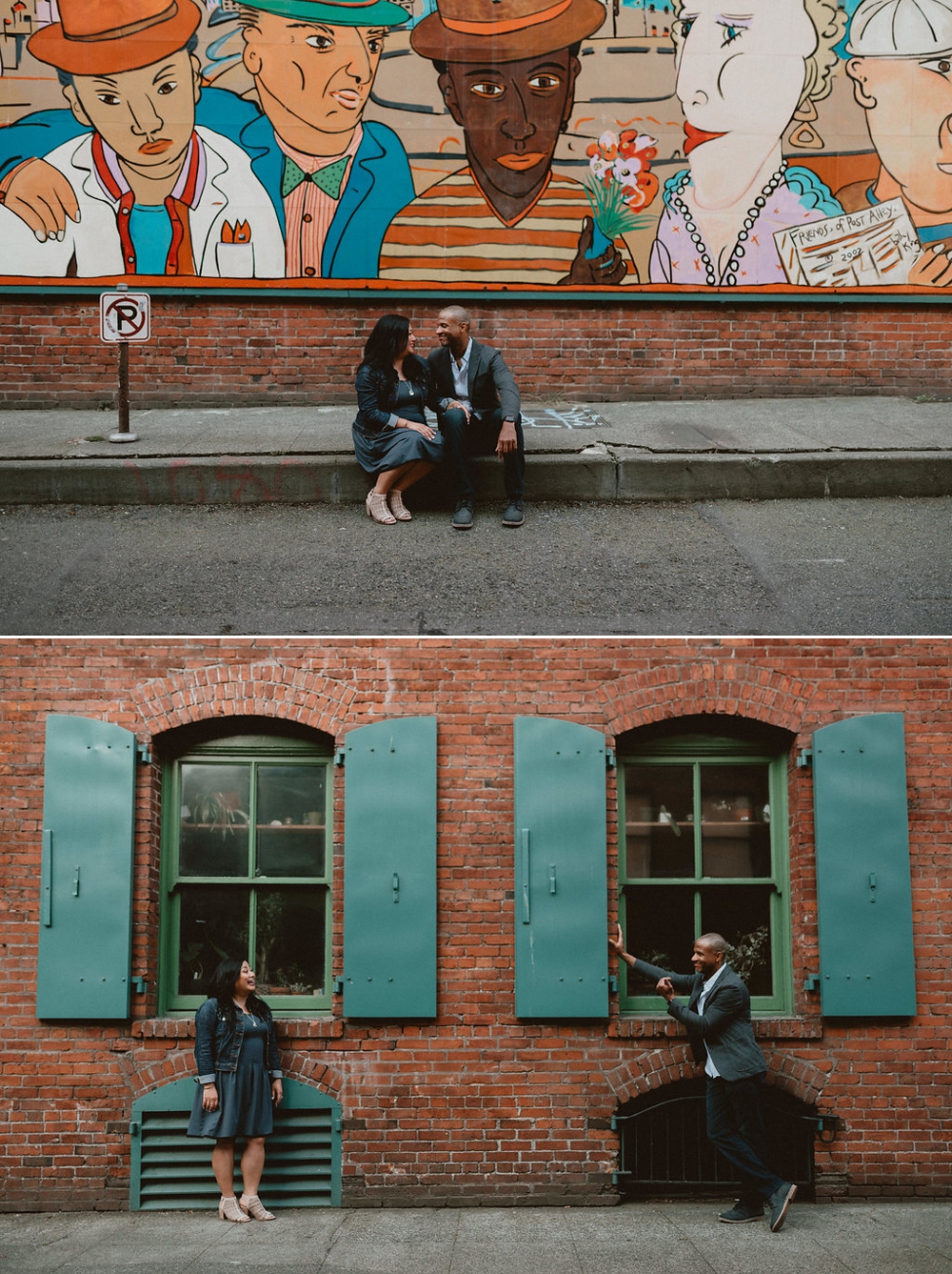 A well-dressed couple smile at each other while sitting on the sidewalk in front of a mural in Seattle for engagement photos.