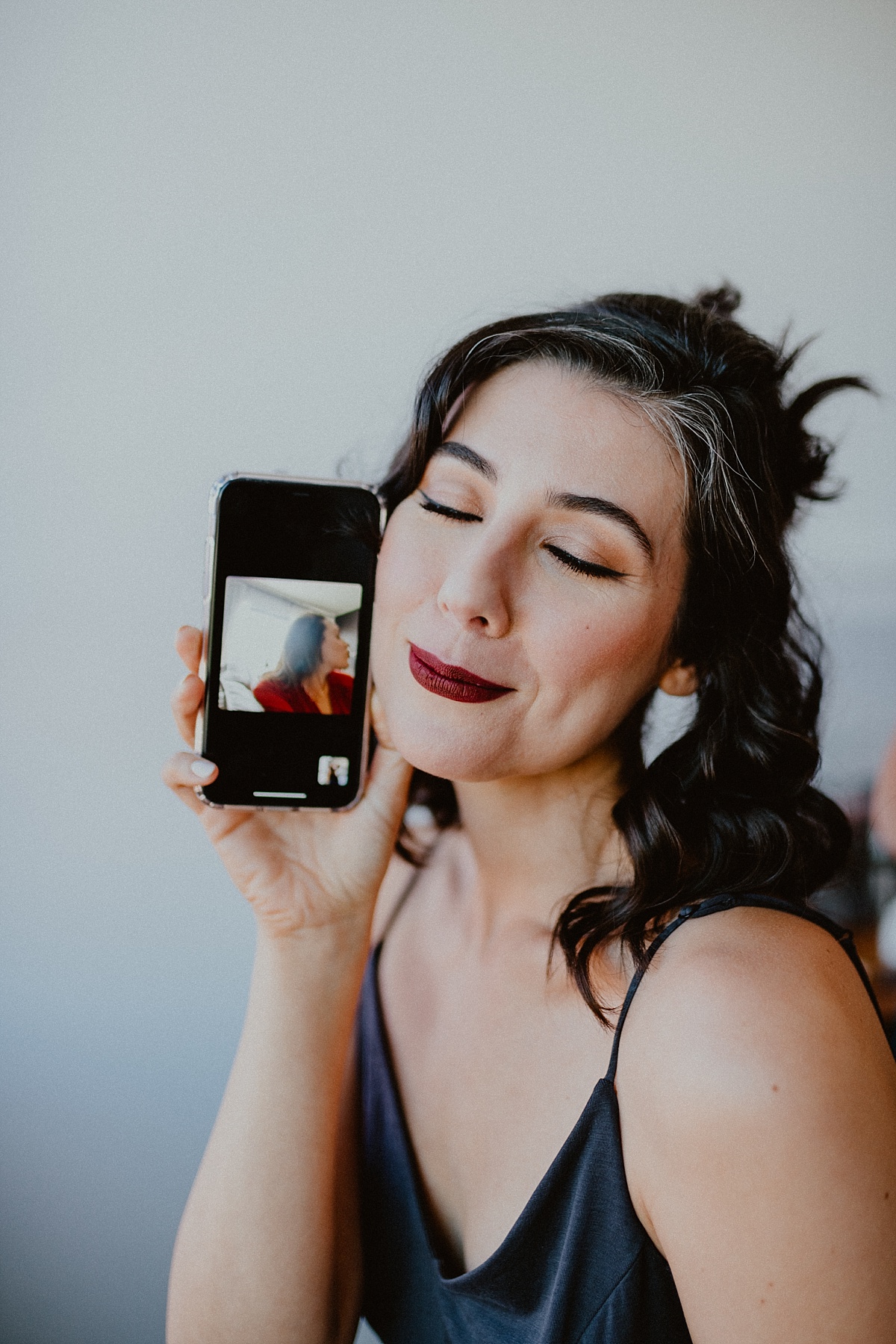 A beautiful bride FaceTimes her friend while getting ready for her elopement during the pademic