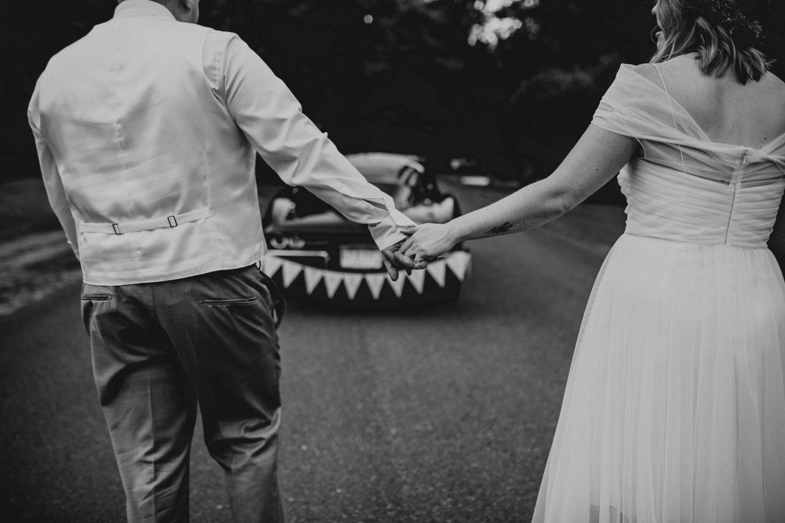 Bride and groom hold hands and walk towards vintage Corvette just married car | Seattle Wedding Photographer, Seattle Elopement Photographer | chelseaabril.com