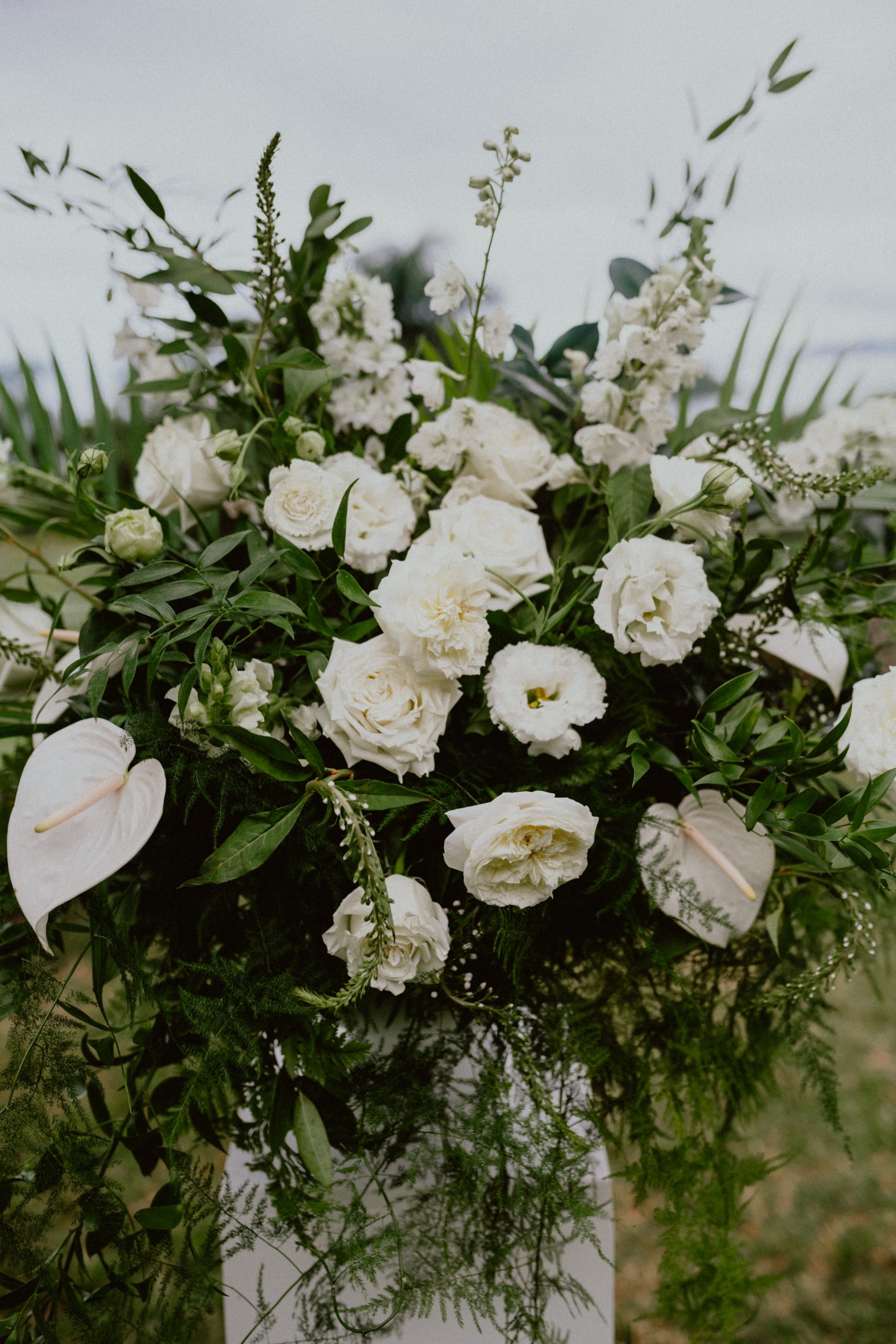 White rose wedding florals with lilies for the ceremony at Kualoa Ranch | Oahu Wedding Photographer, Oahu Elopement Photographer, Destination Wedding Photographer, Destination Elopement Photographer, Newlywed moments ideas, Newlywed Photography inspiration, Hawaii Elopement ideas | chelseaabril.com