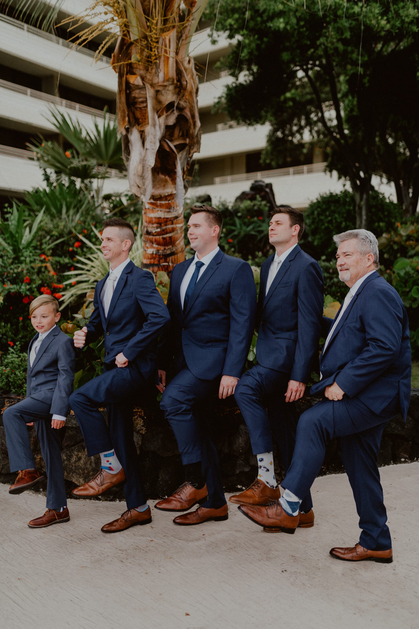 Groom and his wedding party dressed in dark blue suits and ties wearing brown dress shoes with decorative socks | Groom style tips, Groom wedding day inspiration, Groom Tips Wedding, Groom tips for men, Groom tips | chelseaabril.com