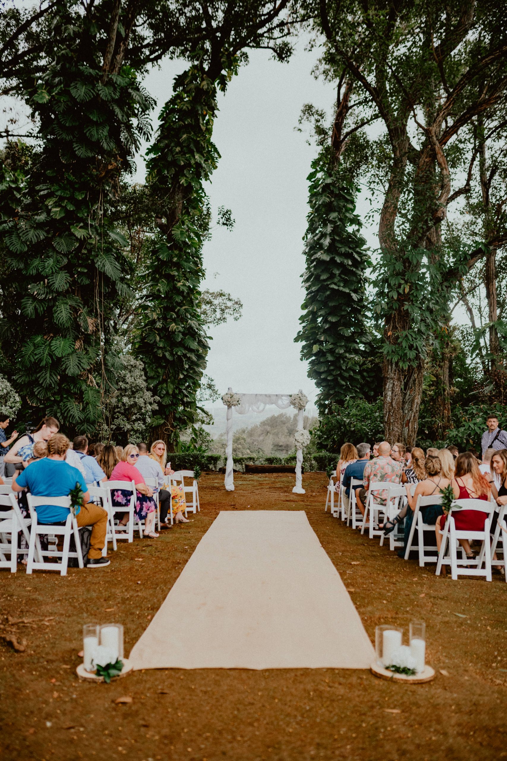 Hawaiian jungle landscape at Sunset Ranch looking out at the altar with wedding guests waiting for bride | Oahu Wedding Photographer, Oahu Elopement Photographer, Destination Wedding Photographer, Destination Elopement Photographer, Newlywed moments ideas, Newlywed Photography inspiration, Hawaii Elopement ideas | chelseaabril.com