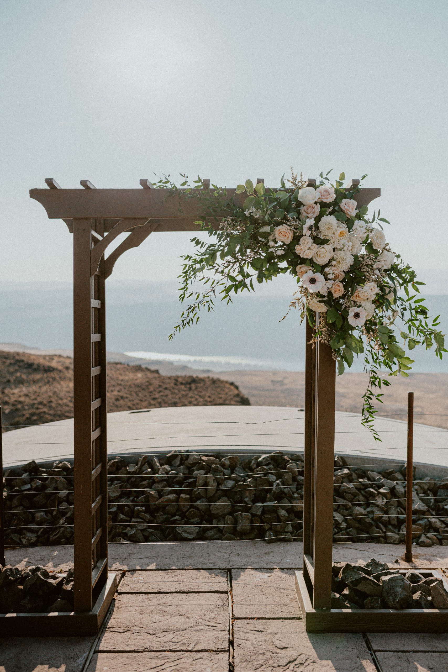 Wedding day floral inspiration with white florals and arch overlooking the ocean for Fall PNW wedding inspiration | Washington Elopement, Destination Elopement Photographer, Cave B Inn Elopement Inspiration, Washington Elopement ideas, PNW Fall Wedding Inspiration, Fall Outdoor Wedding Ideas,Fall Wedding Inspiration, PNW Outdoor Wedding Ideas | chelseaabril.com