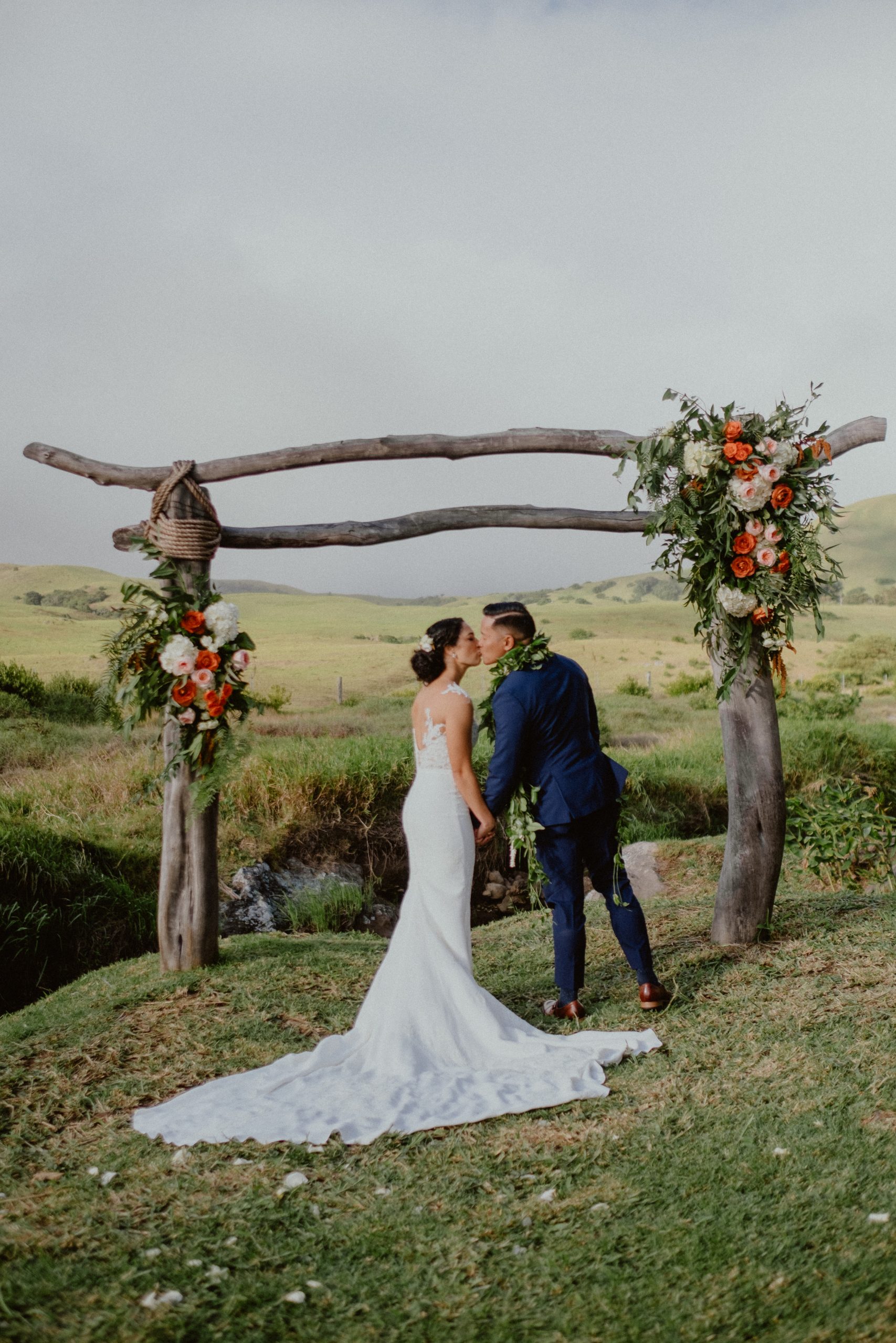 Fall Big Island wedding day photography and Bridal photography with white wedding dress with long train and lace and groom wears a dark blue suit | Big Island Elopement, Hawaii Elopement Photographer, Hawaii Elopement and Wedding Inspiration, Hawaii Elopement ideas, Big Island Wedding Inspiration, Fall Hawaiian Wedding Ideas, Fall Wedding Inspiration, Hawaii Outdoor Wedding Ideas | chelseaabril.com