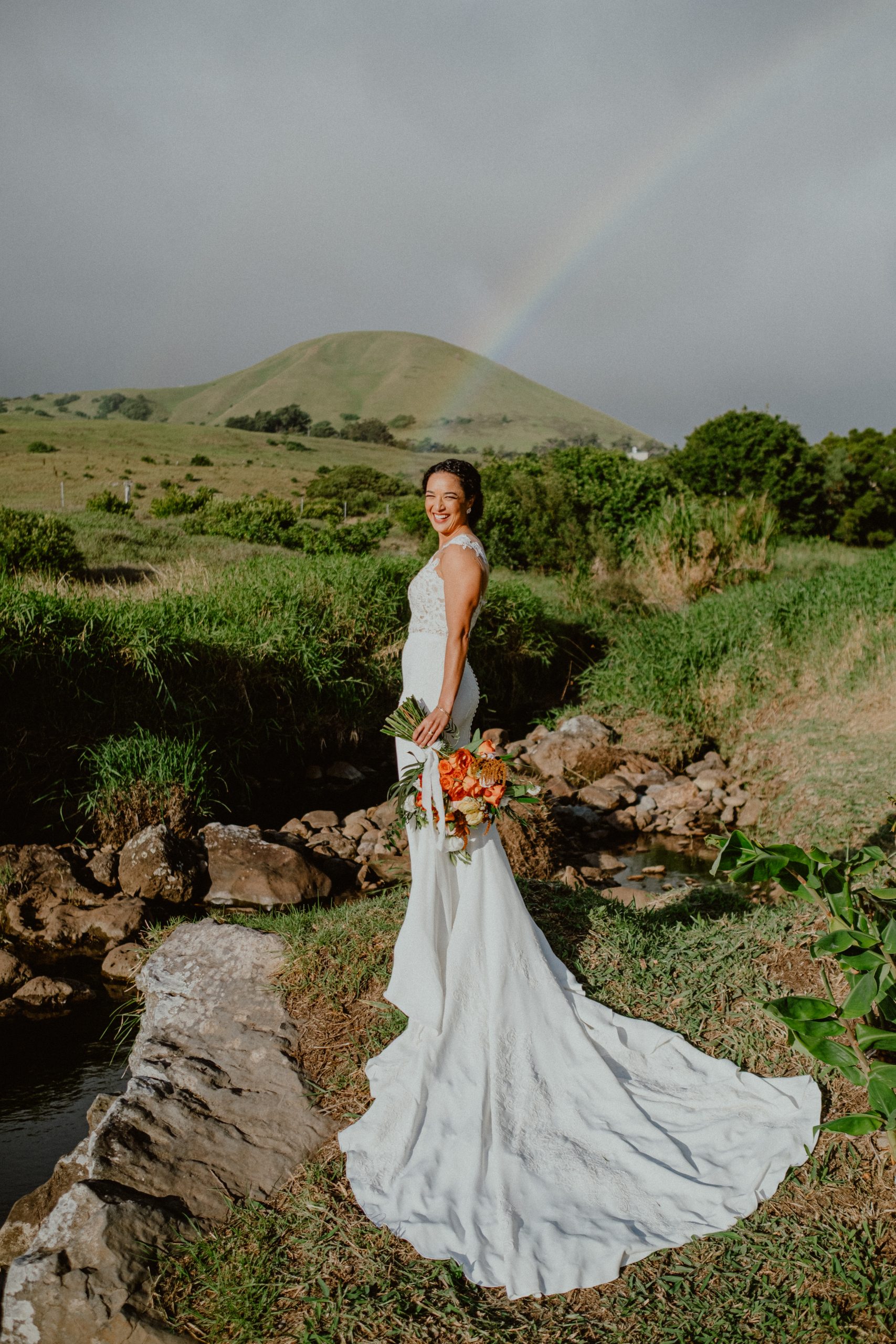 Fall bridal wedding day photography with white lace gown and long train with Hawaiian rainbow over Big Island wedding location inspiration Bride style wedding day inspriation | Big Island Elopement, Hawaii Elopement Photographer, Hawaii Elopement and Wedding Inspiration, Hawaii Elopement ideas, Big Island Wedding Inspiration, Fall Hawaiian Wedding Ideas, Fall Wedding Inspiration, Hawaii Outdoor Wedding Ideas | chelseaabril.com