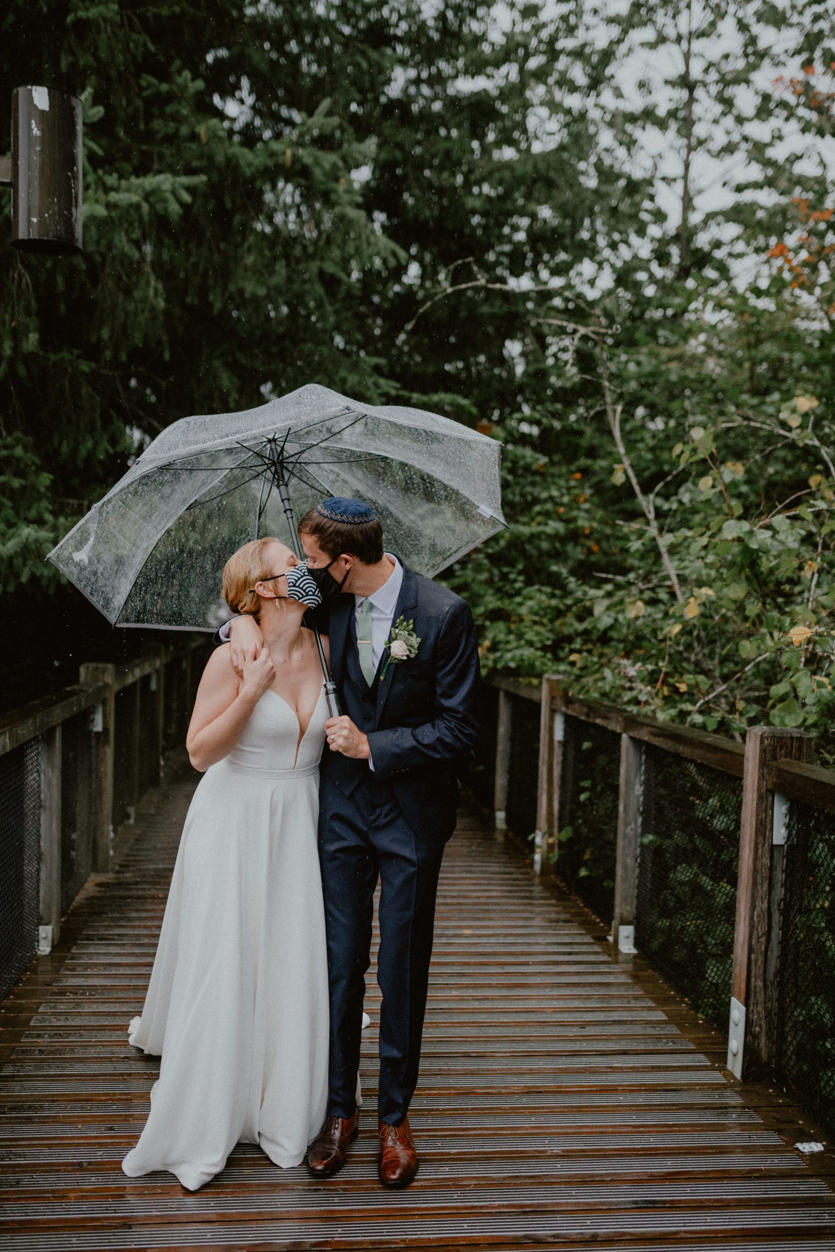 Bride and groom kiss at outdoor PNW wedding reception under long bridal veil in the rain, newlywed photography inspiration Bride and groom kiss post wedding ceremony inspiration | Seattle Elopement, Washington Elopement Photographer, Washington Elopement and Wedding Inspiration, Seattle Elopement ideas, PNW Wedding Inspiration, Fall Rainy PNW Wedding Ideas, Fall Wedding Inspiration, PNW Outdoor Wedding Ideas | chelseaabril.com