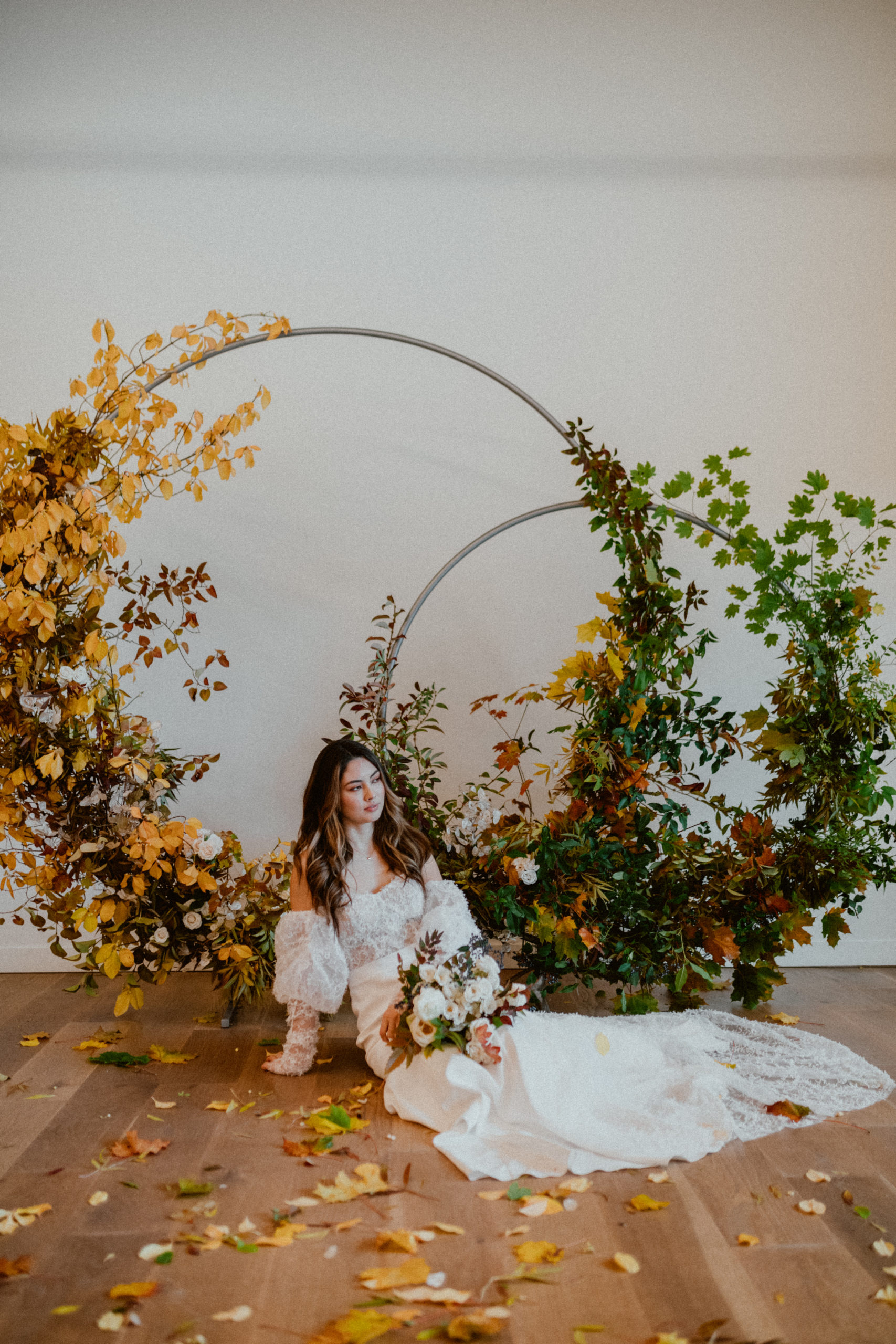 Bride holding flowers with arbor background in block 41 seattle fall inspired wedding