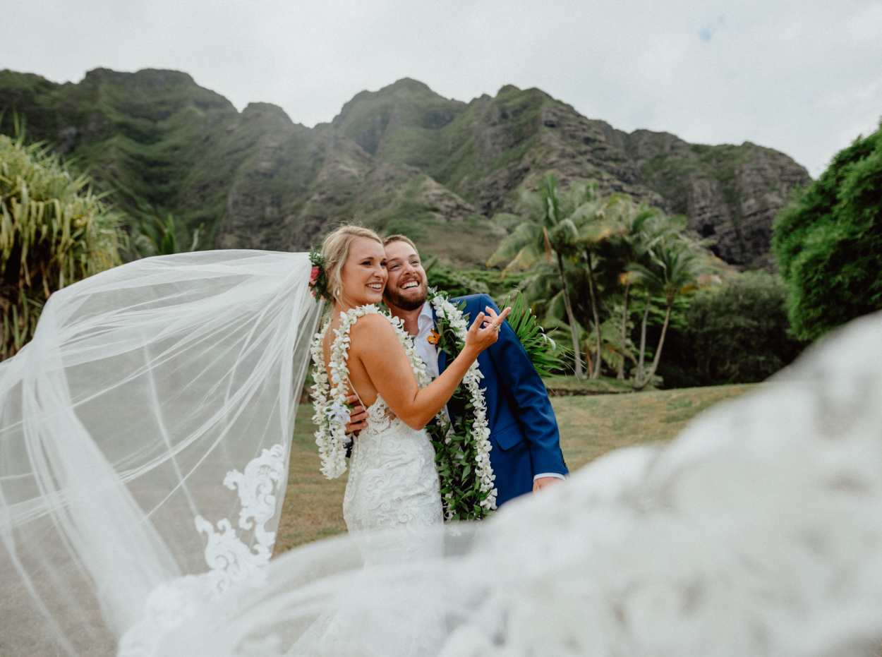 Bride and groom enjoying the scenery in Paliku Gardens Kualoa Ranch wedding with Koʻolau Range backdrop