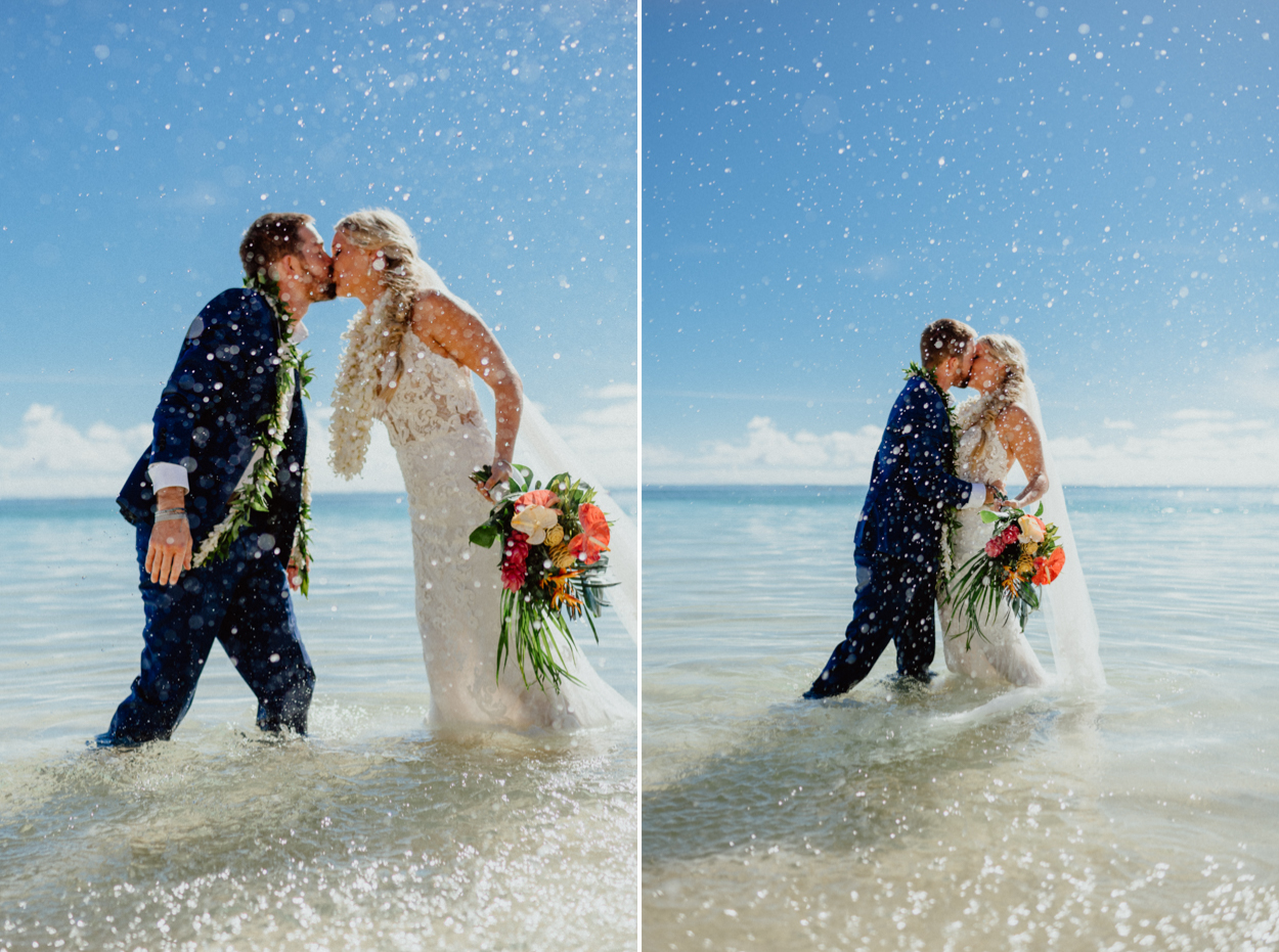Bride and groom kiss with water spash in Lanikai Beach
