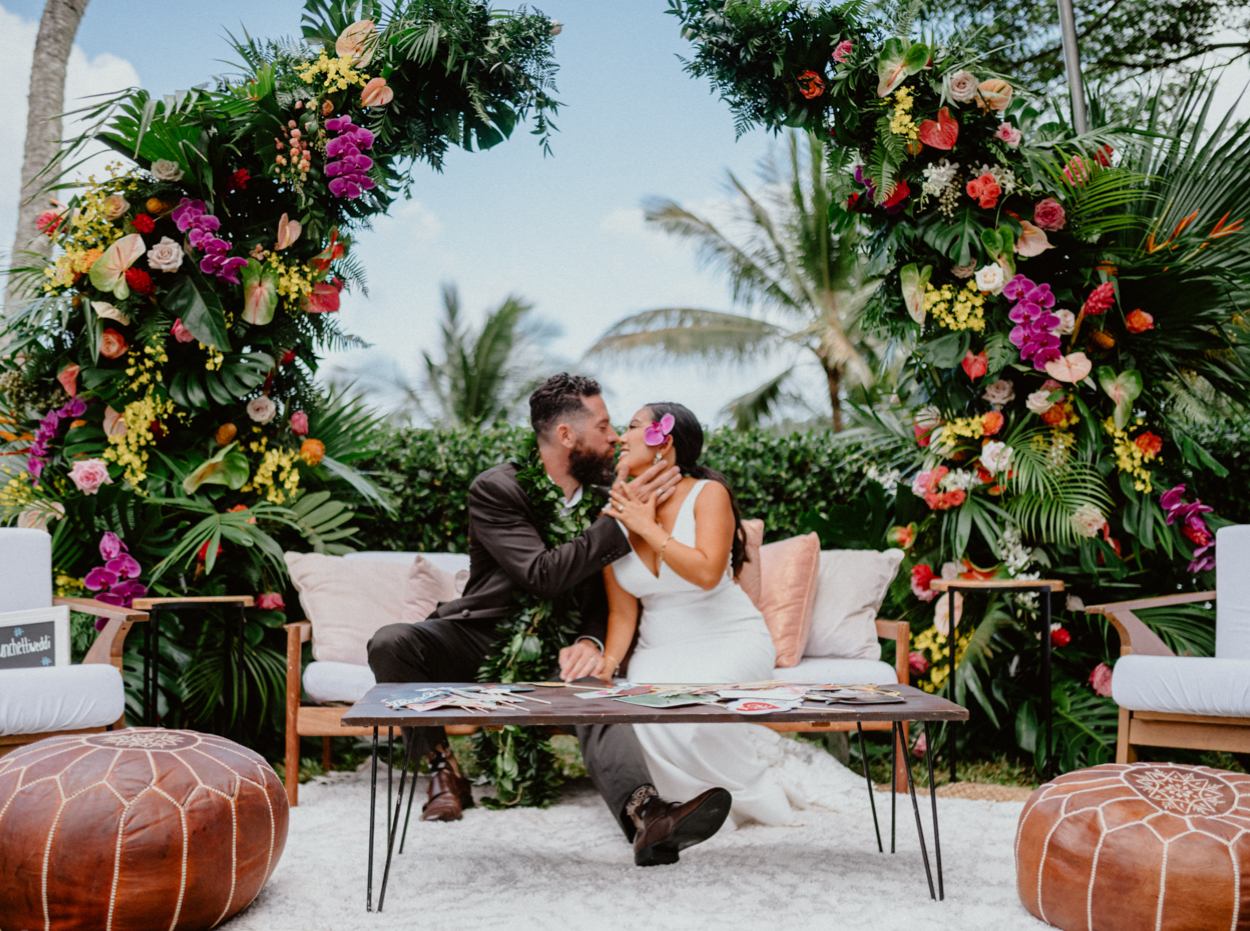 Moli'i fishpond Hawaii wedding rentals from aloha artisans. bride and groom kiss.