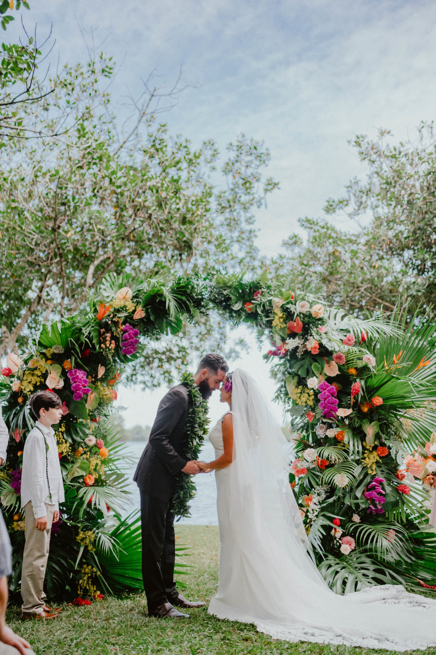 Moli'i fishpond Hawaii bride and groom wedding ceremony shot under the wedding arch