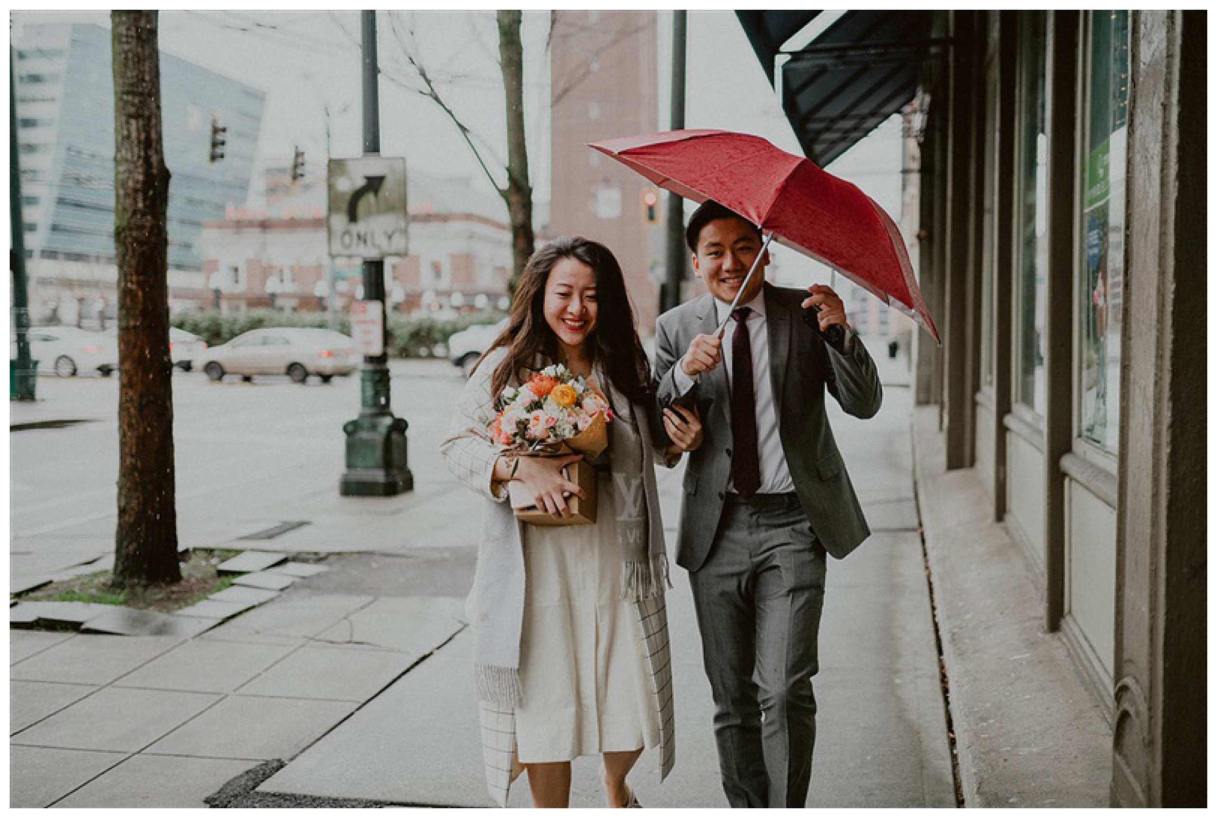 bride and groom walking together in rain downtown seattle 